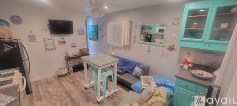 A kitchen with a table and chairs in the middle of the room.
