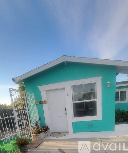 A small house with a white door and window is for sale.