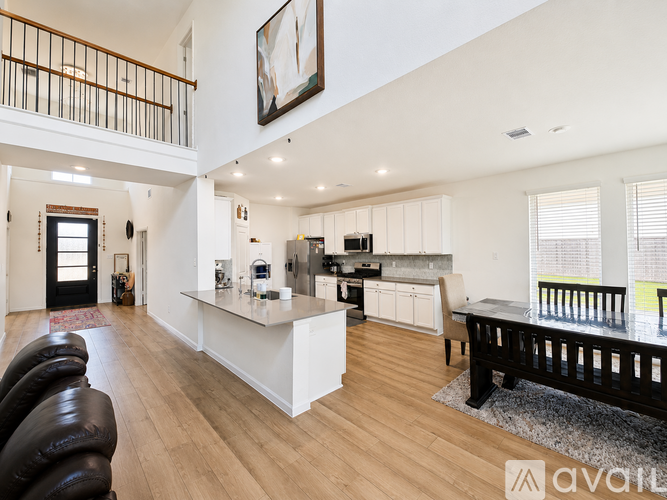 A modern kitchen with white cabinets and a large island.