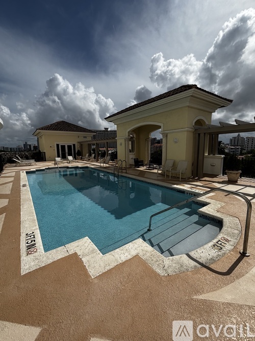 A swimming pool with a building in the background.