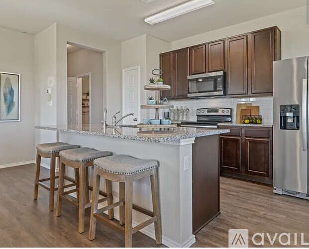 A kitchen with brown cabinets and a white countertop.