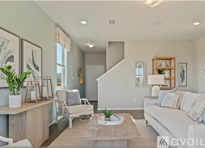 A living room with a white couch and a wooden coffee table.