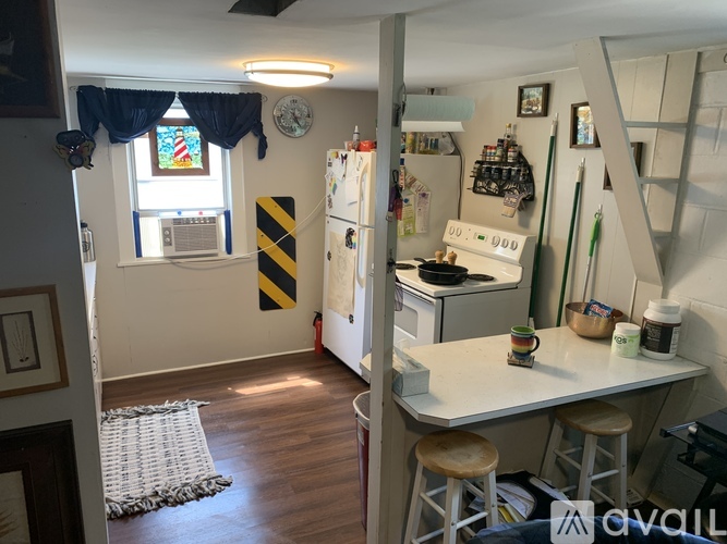 A kitchen with a white fridge and a white counter top.
