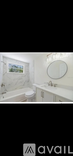 A bathroom with a toilet, sink, and a window.