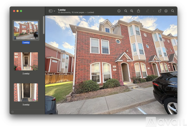 A webpage displays a large image of a red brick apartment building with a car parked in front.