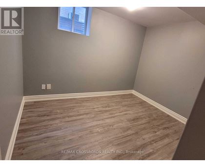 A room with wooden flooring and a window.