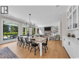 A modern dining room with a large table and chairs.