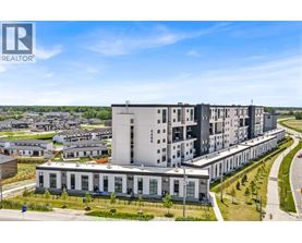 A modern apartment complex with a clear blue sky above.