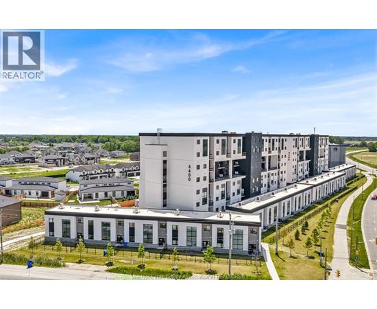 A modern apartment complex with a clear blue sky above.