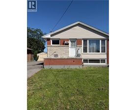 A house with a porch and a white door is for sale.