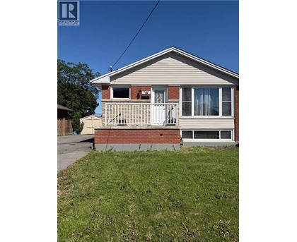 A house with a porch and a white door is for sale.