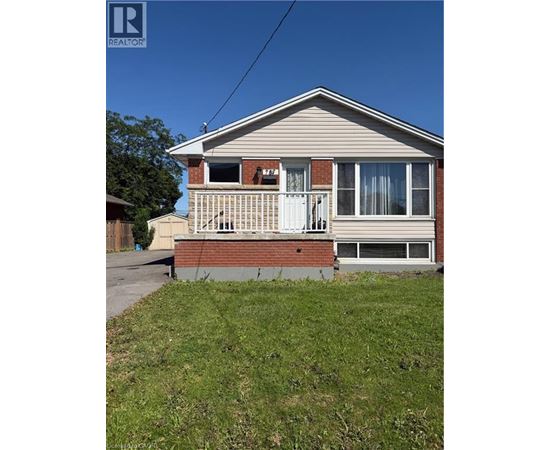 A house with a porch and a white door is for sale.