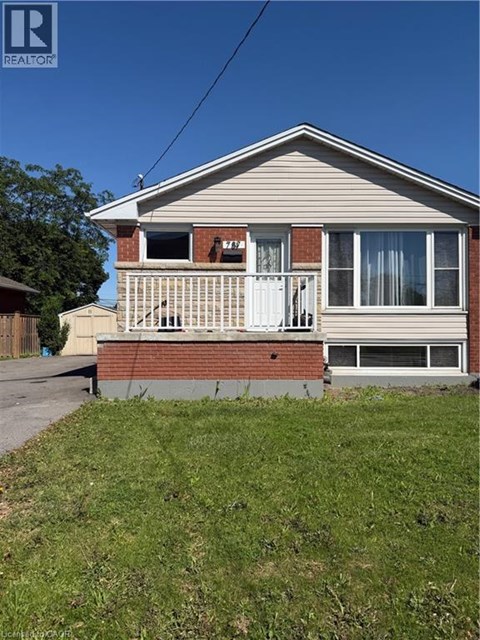 A house with a porch and a white door is for sale.