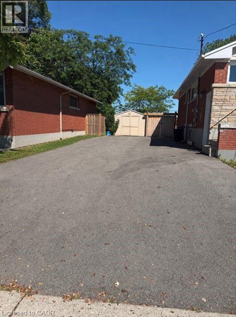 A driveway leads to a house with a garage.