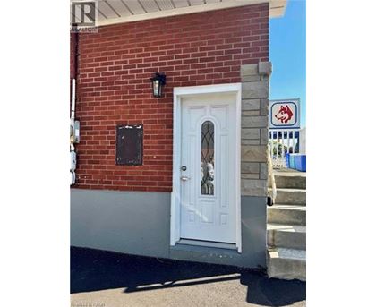 A white door is on a red brick building.