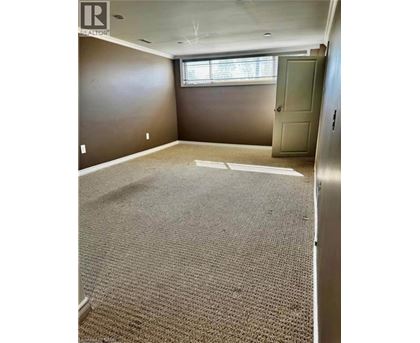 A room with a carpeted floor and a door.