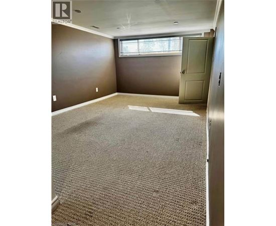 A room with a carpeted floor and a door.