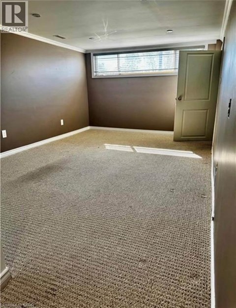 A room with a carpeted floor and a door.