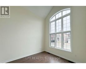 A room with a large window and a view of the street outside.