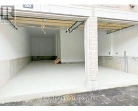 A garage with a white interior and a partially open door.