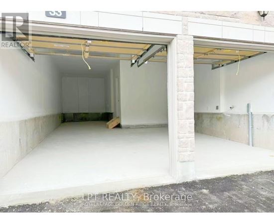 A garage with a white interior and a partially open door.