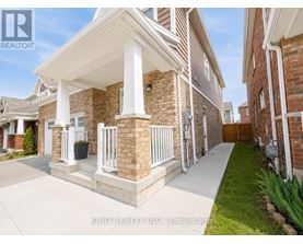 A house with a white porch and a brick exterior.