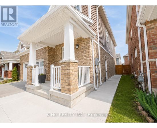 A house with a white porch and a brick exterior.