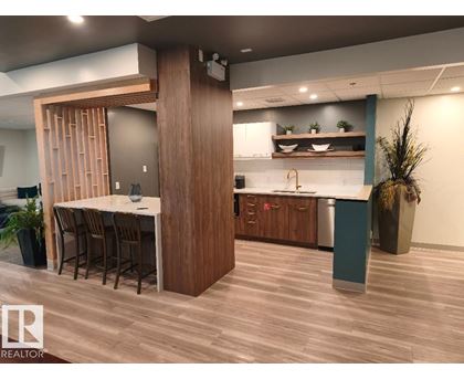 A modern kitchen with a dining table and chairs.