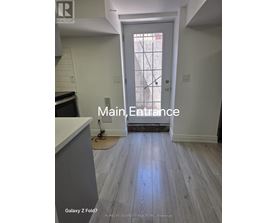 A white door with a glass window is the main entrance to a home.