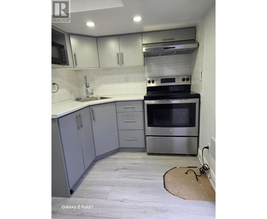 A kitchen with a stove top oven and a microwave.