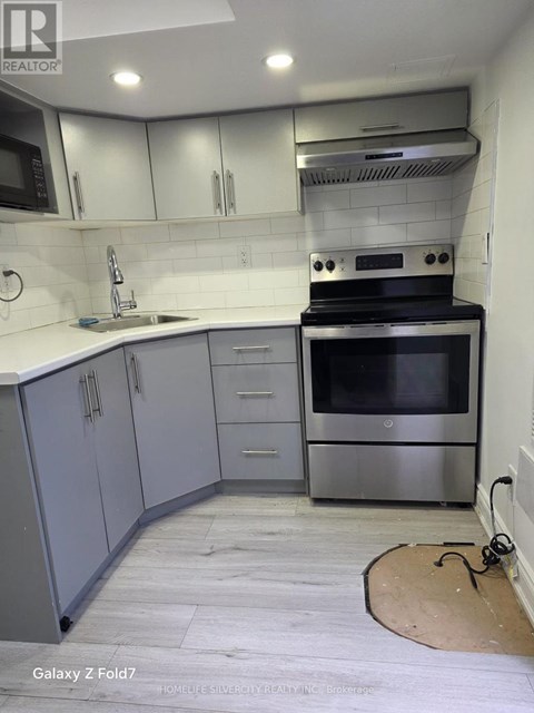 A kitchen with a stove top oven and a microwave.