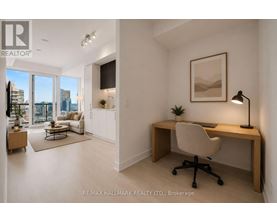 A well-lit room with a desk and a chair.