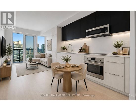 A modern kitchen with a dining table set for two.