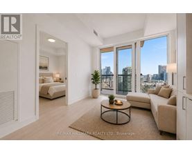 A spacious living room with a view of the city skyline.