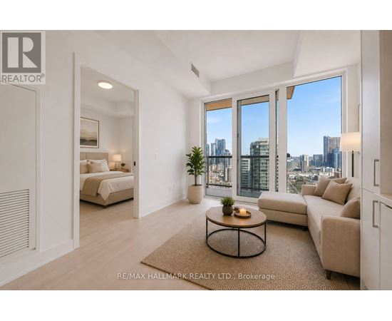A spacious living room with a view of the city skyline.