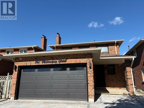 A house with a garage door and a brick wall.