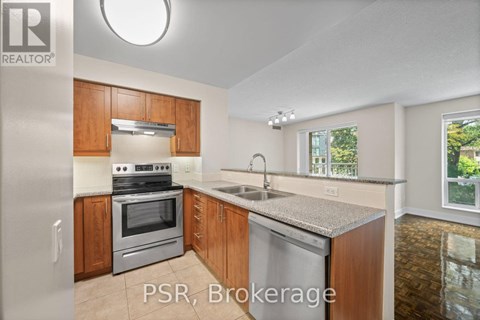 A kitchen with wooden cabinets and stainless steel appliances is on the market.