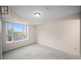 A room with a large window and carpeted floor.