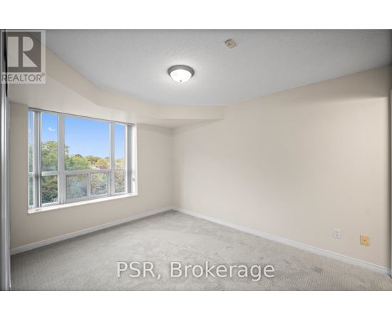A room with a large window and carpeted floor.