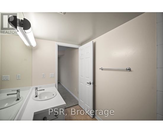 A bathroom with a sink, mirror, and towel bar.