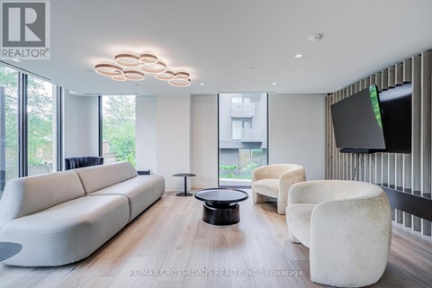 A modern living room with a white sofa and a black coffee table.