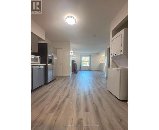 A kitchen with a refrigerator, dishwasher, and oven.