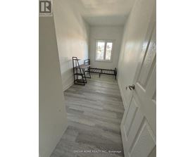 A hallway with a bench and a window.