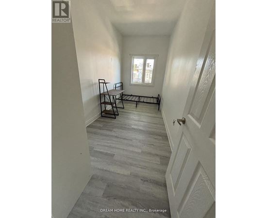 A hallway with a bench and a window.
