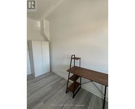 A room with a wooden table and a white cabinet.