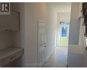 A white door in a hallway with a window in the background.