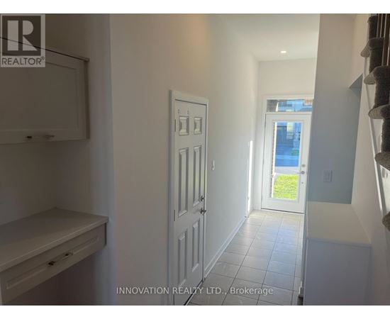 A white door in a hallway with a window in the background.