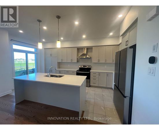 A modern kitchen with white cabinets and a large island.