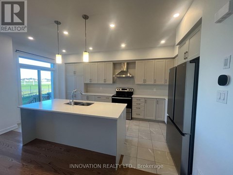 A modern kitchen with white cabinets and a large island.