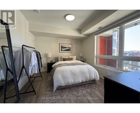 A bedroom with a large bed and a view of the city.